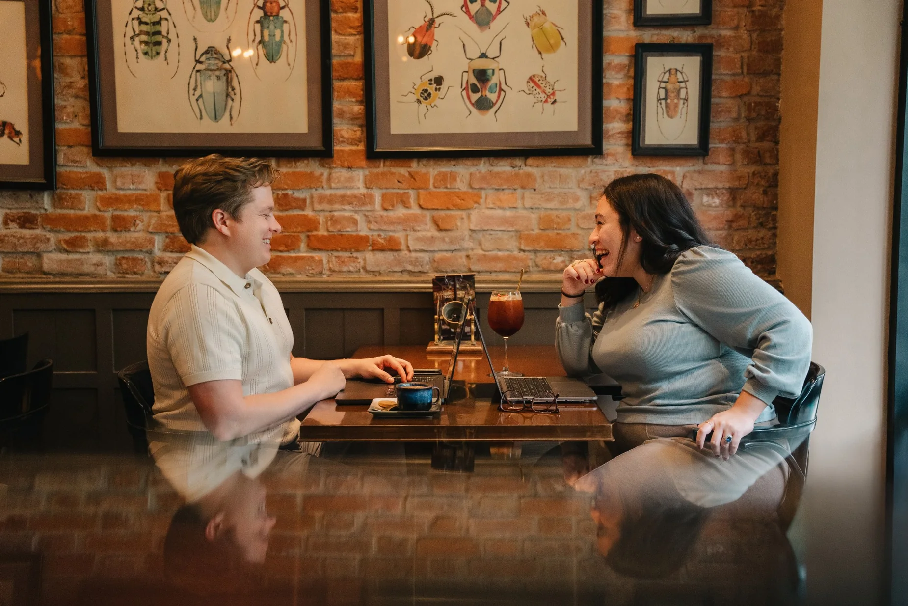 Justin and Abigail Hardy laughing together at a café table